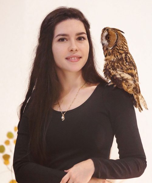 woman-in-witch-costume-holding-owl-8MPSLWH